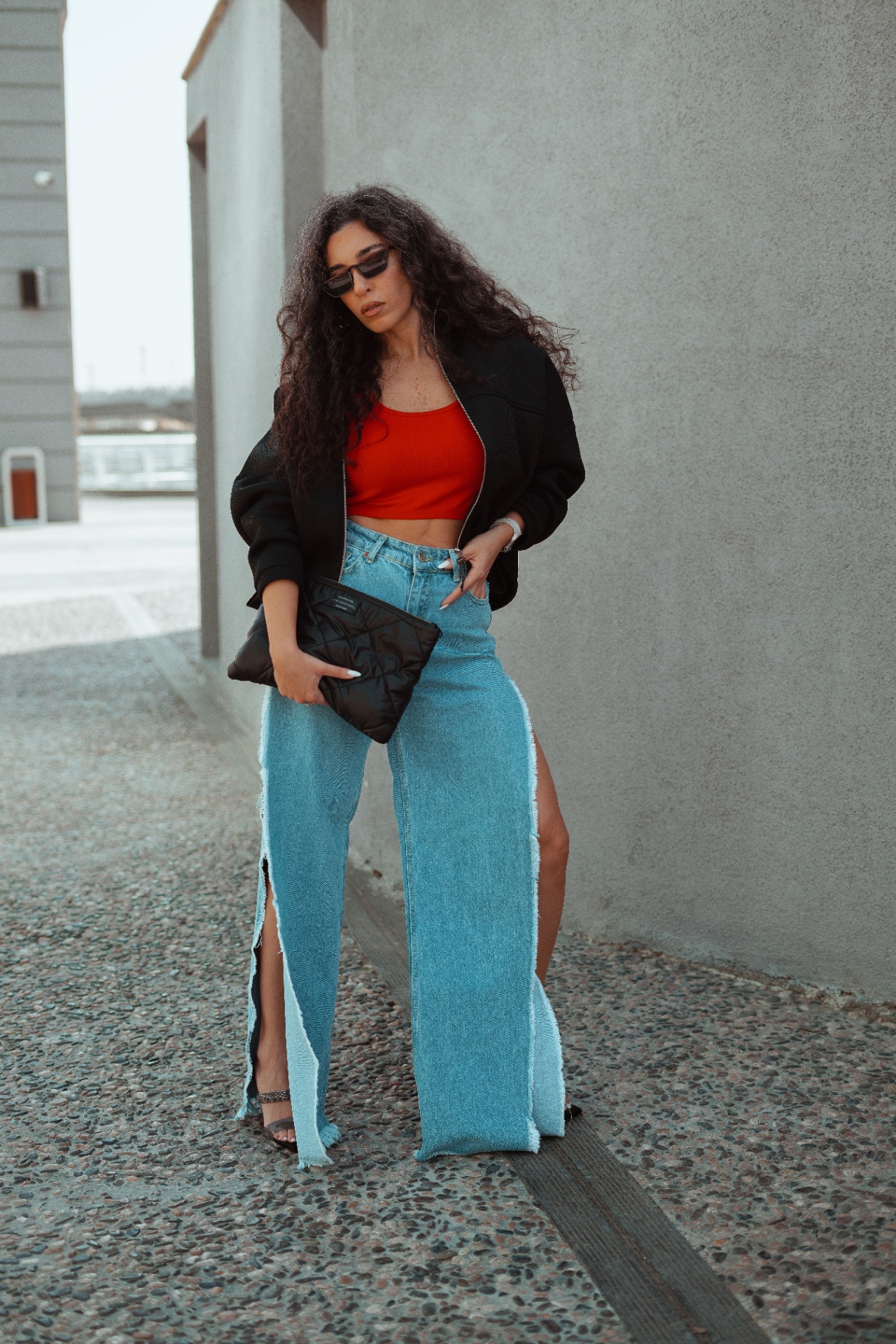 Woman in red crop top and wide-leg patchwork denim maxi with side splits