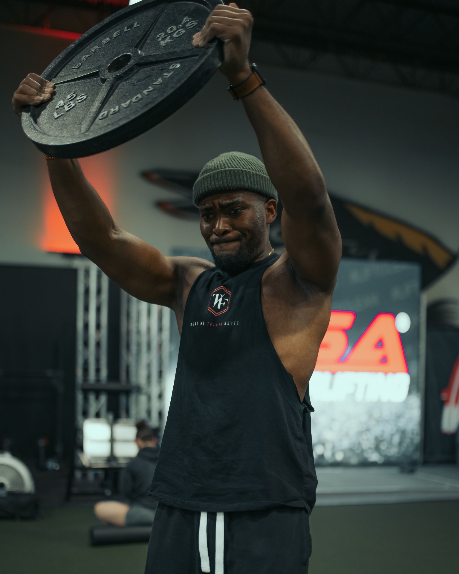 Athlete training in a black performance tank top
