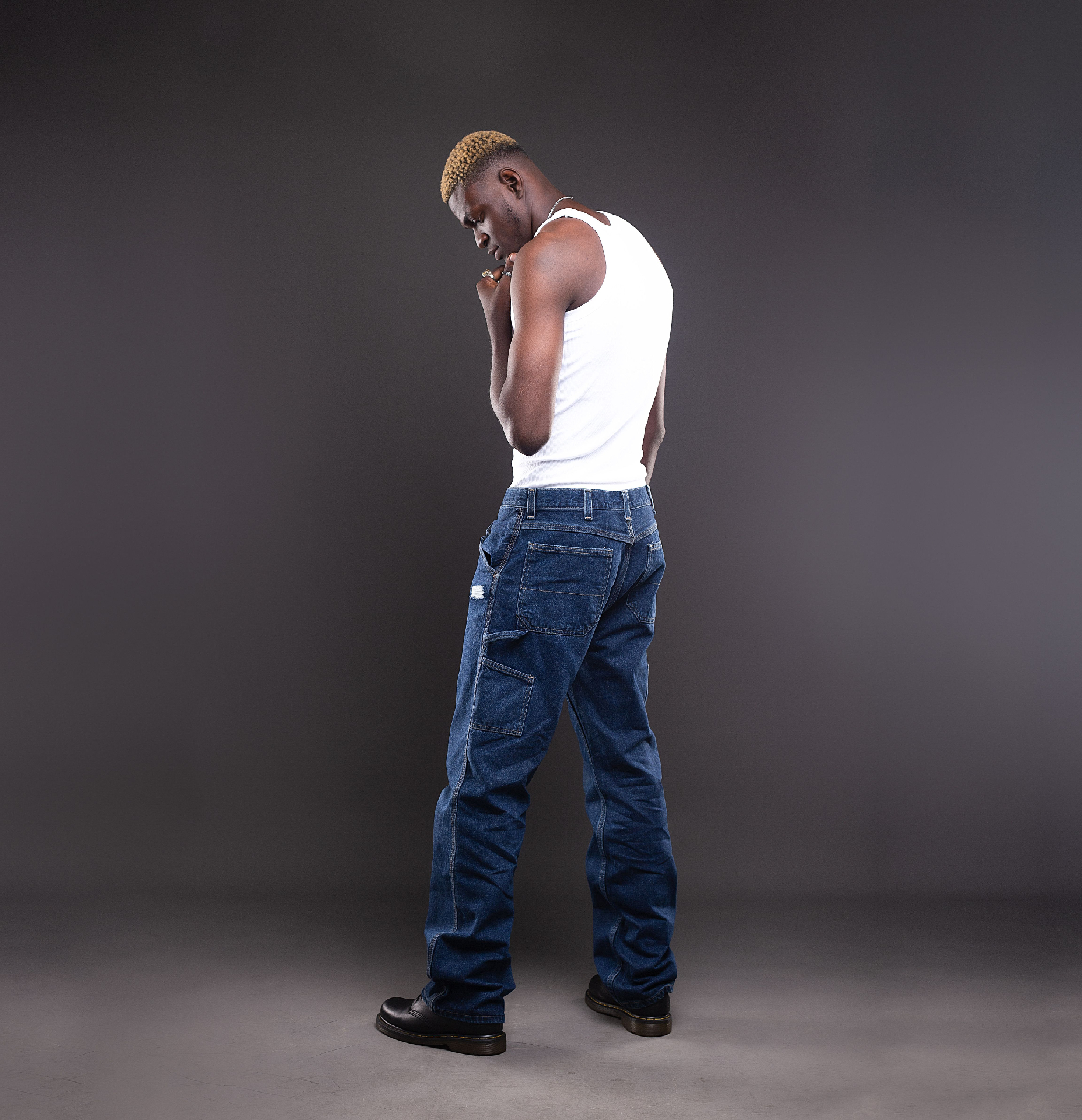 Model wearing relaxed-fit carpenter jeans with white tank