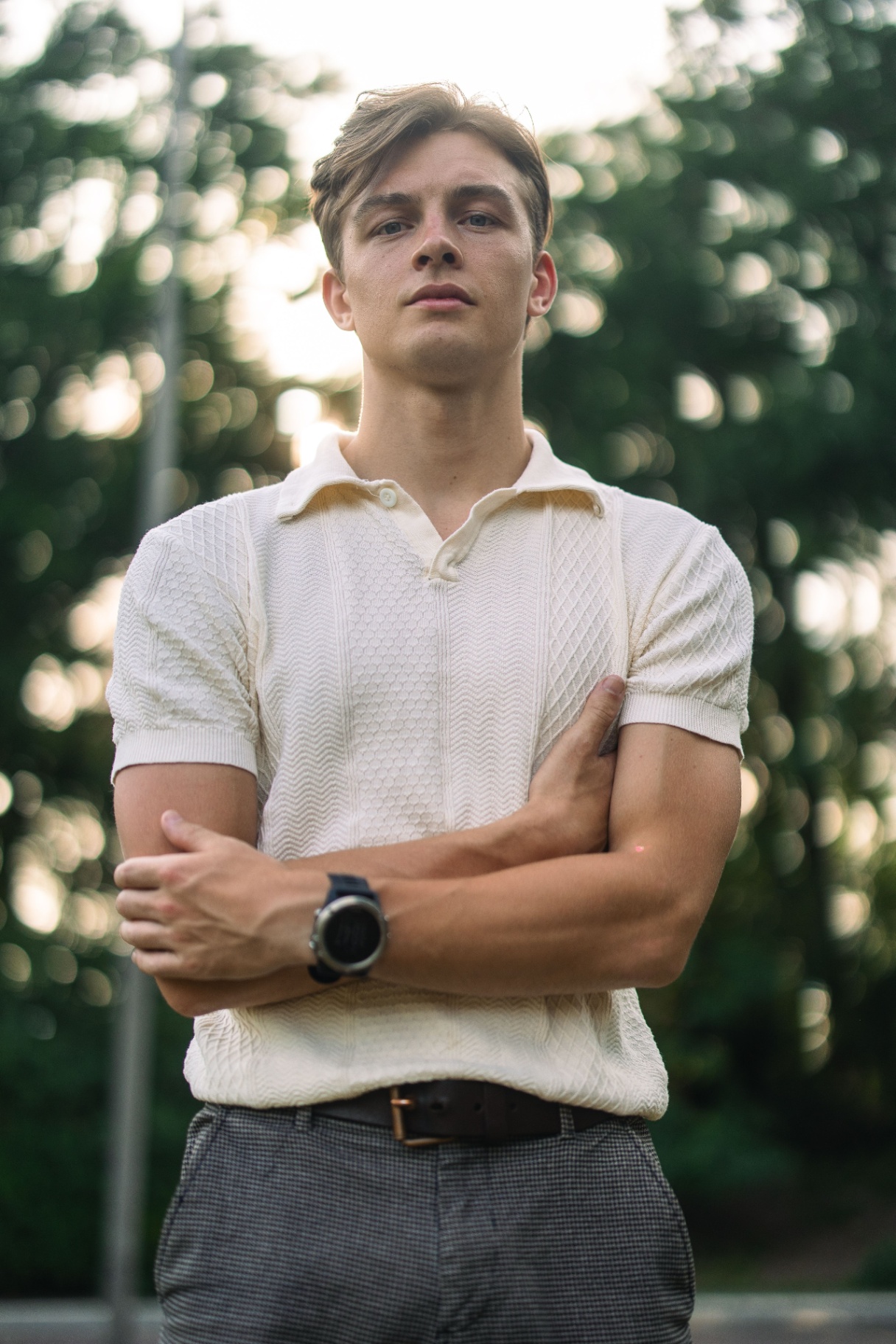 Man in textured ivory knit polo outdoors