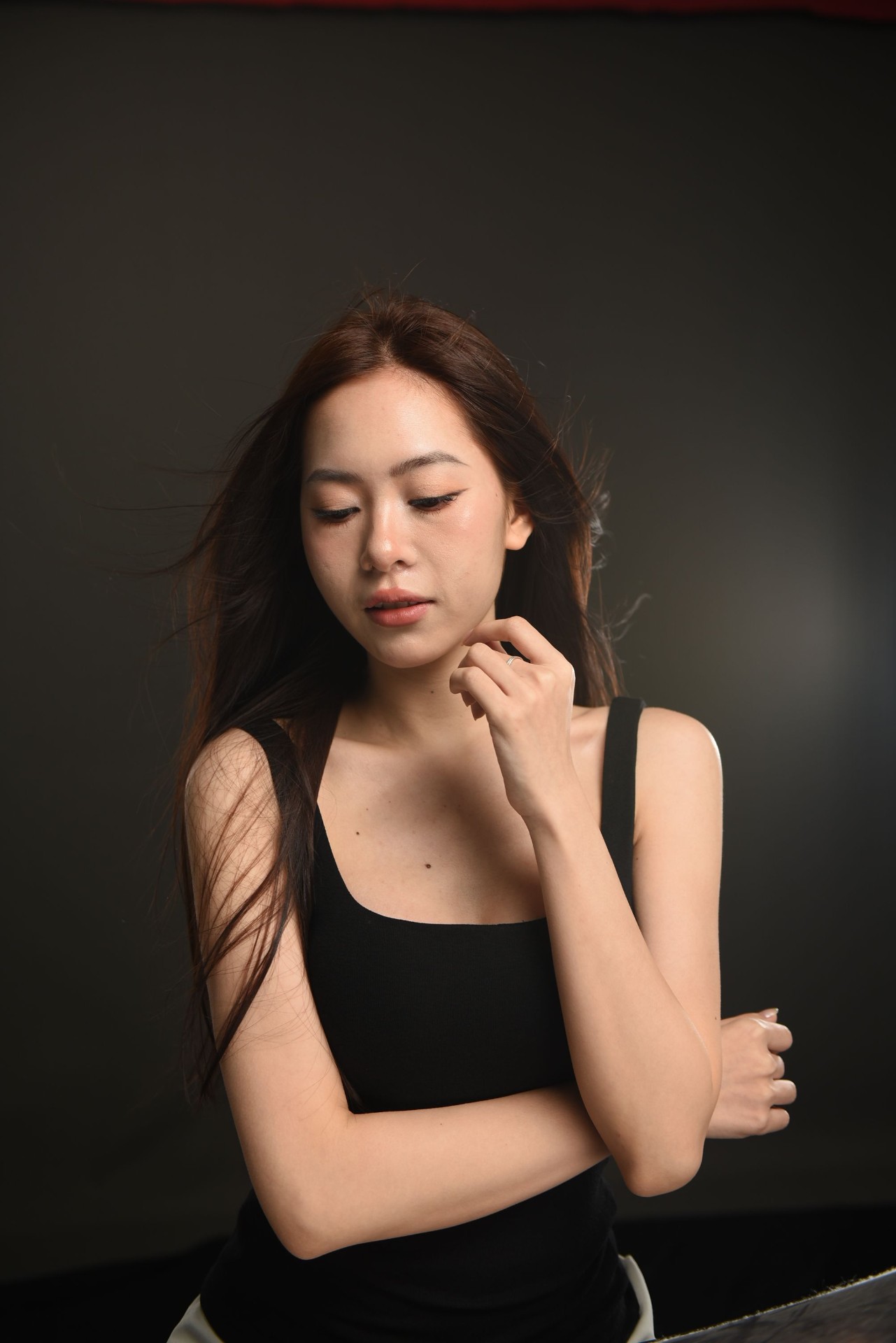 Studio portrait of a woman in a black scoop-neck tank top