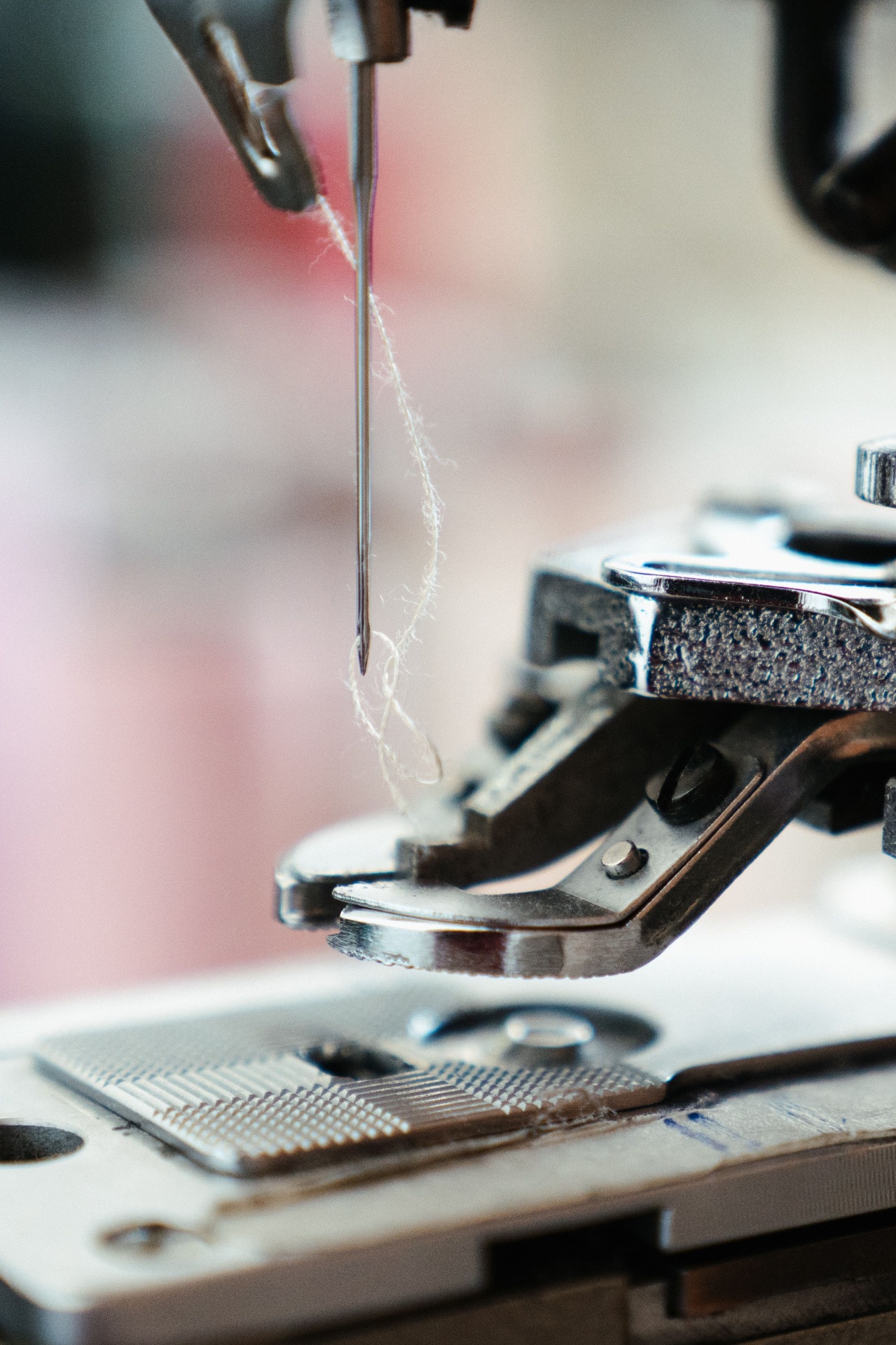 Close-up of a sewing machine needle stitching fabric