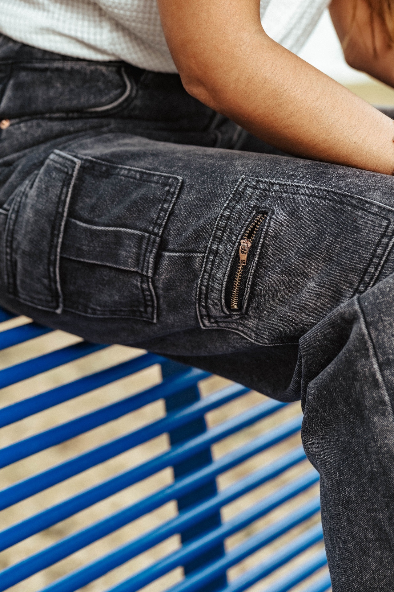 Detail of black washed denim with zipper pocket