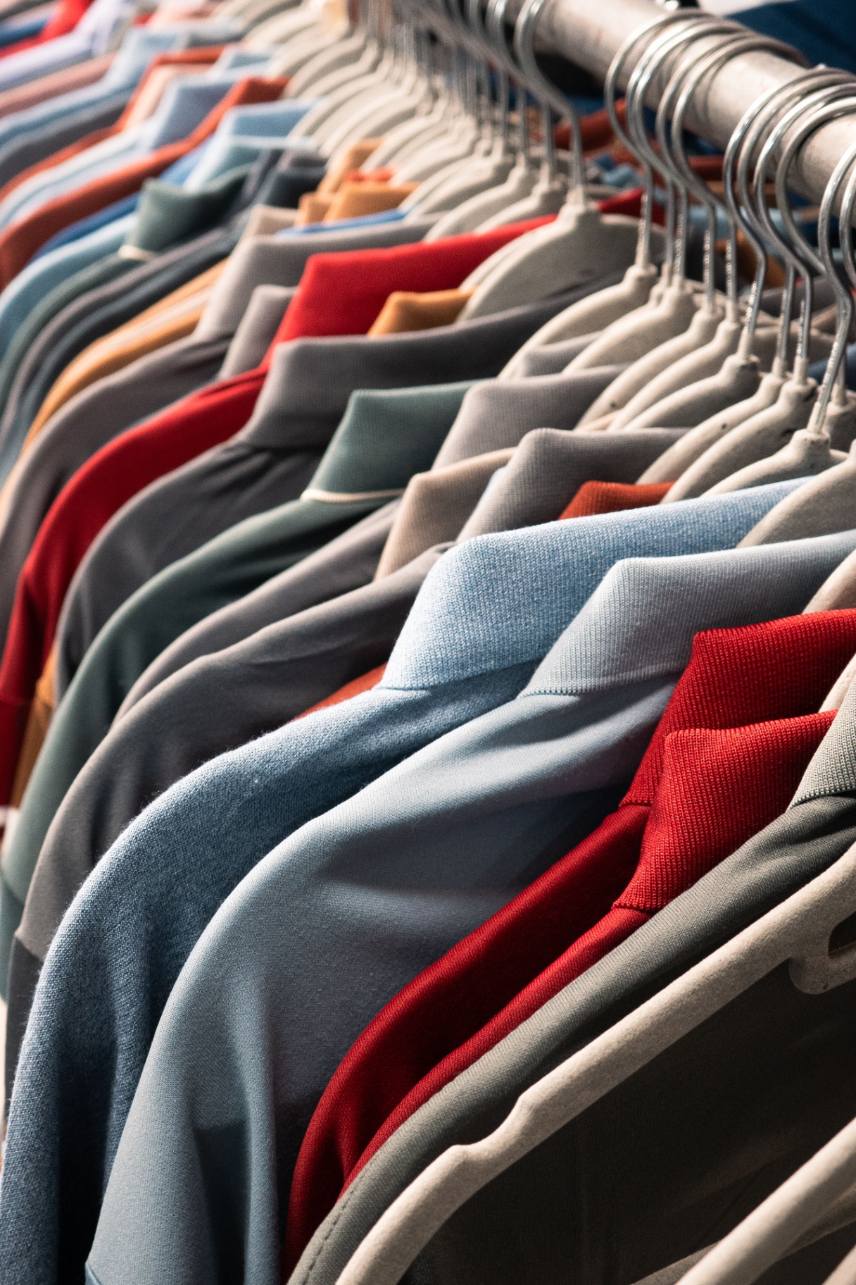 Row of polos in multiple colours on hangers
